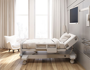Side view of a gray walled hospital ward with a bed, a tv set, a white armchair and curtains on large windows. 3d rendering, Mock up